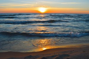 Brilliant sunrise over the waters of lake Huron in Oscoda, Michi